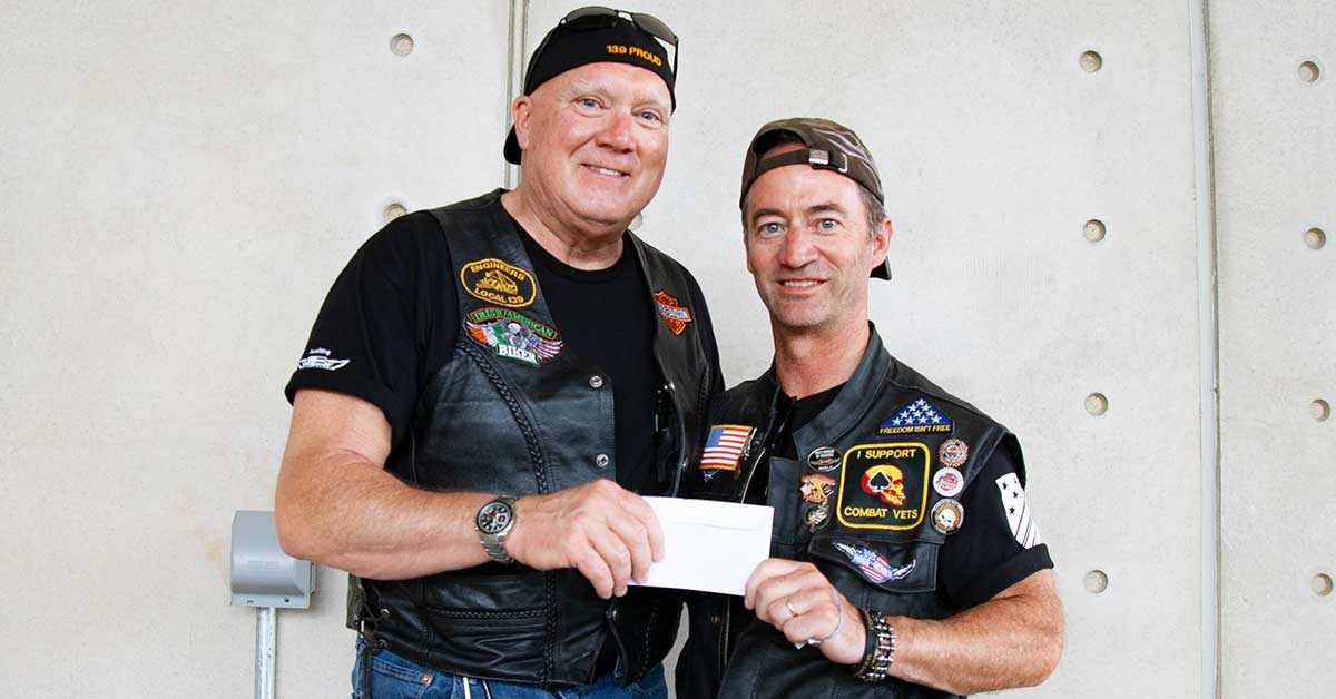 President/Business Manager Terry McGowan presenting Hogs for Heroes Founder Kevin Thompson.