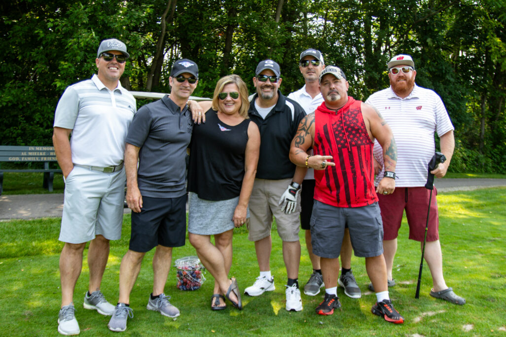 (L-R) Jason Higgins, Hogs for Heroes Kevin and Audra Thompson, Tim Bezoenik, Tony Caminata, #37 Bike Recipient Earl Beaudry, and Eric Christoph