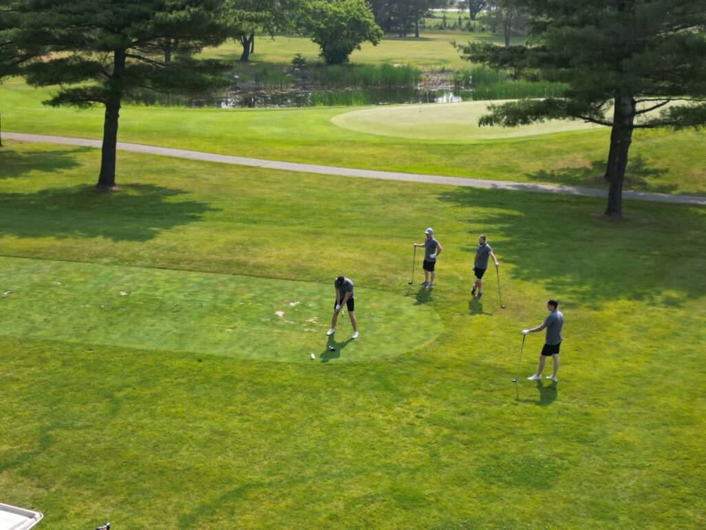 Drone view of golfers John Bauer, Joe Bauer, Rob Holzberger, and Daniel Holzberger