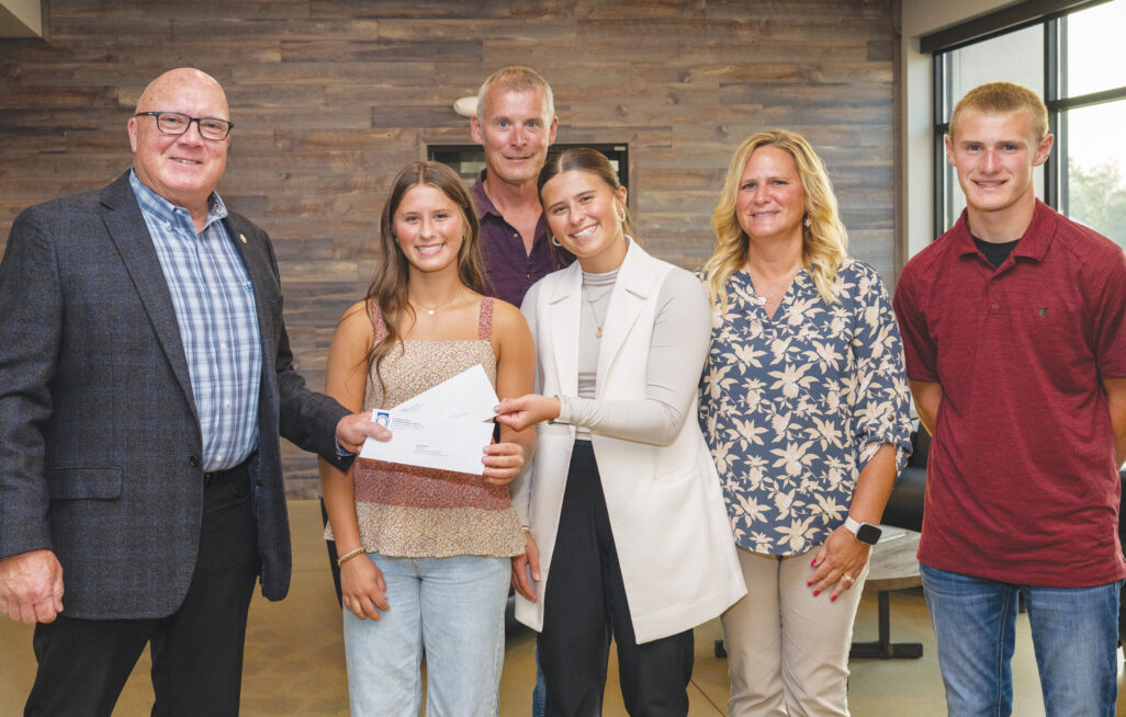 District D scholarship recipients Karli and Kali Fischer with President/Business Manager Terry McGowan, parents Kenneth Fischer (member) and Kim, and brother Kullen.